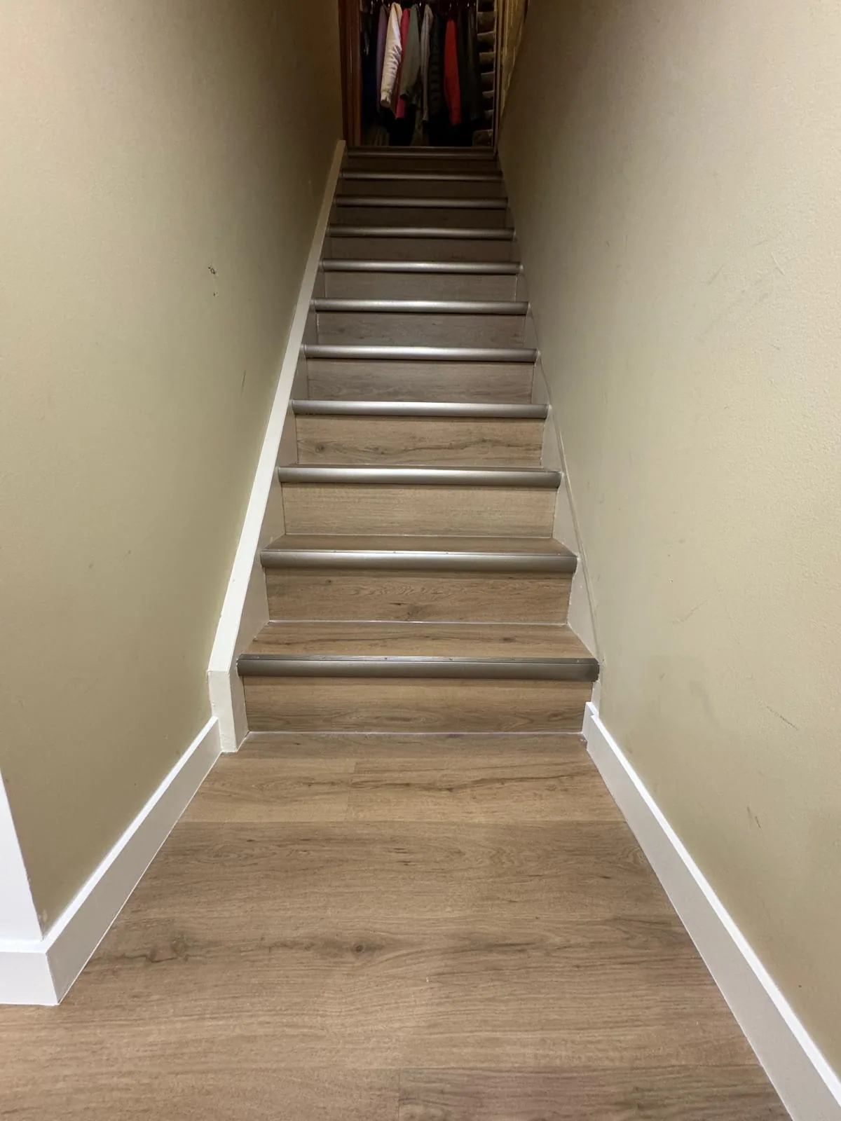 Rebuilt basement stair, wood treads running up to the main floor