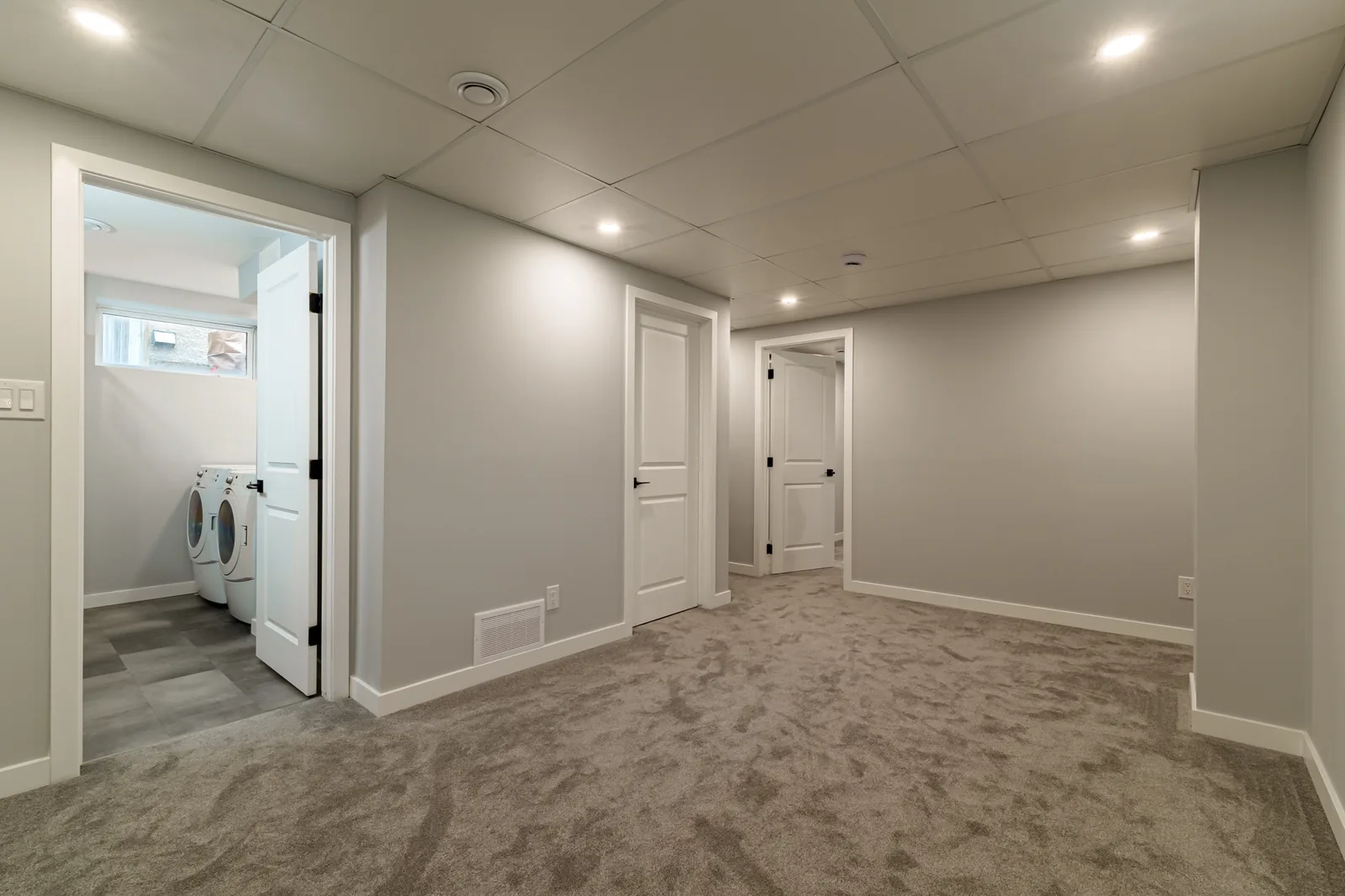 Basement hall with the laundry pair set into its own alcove