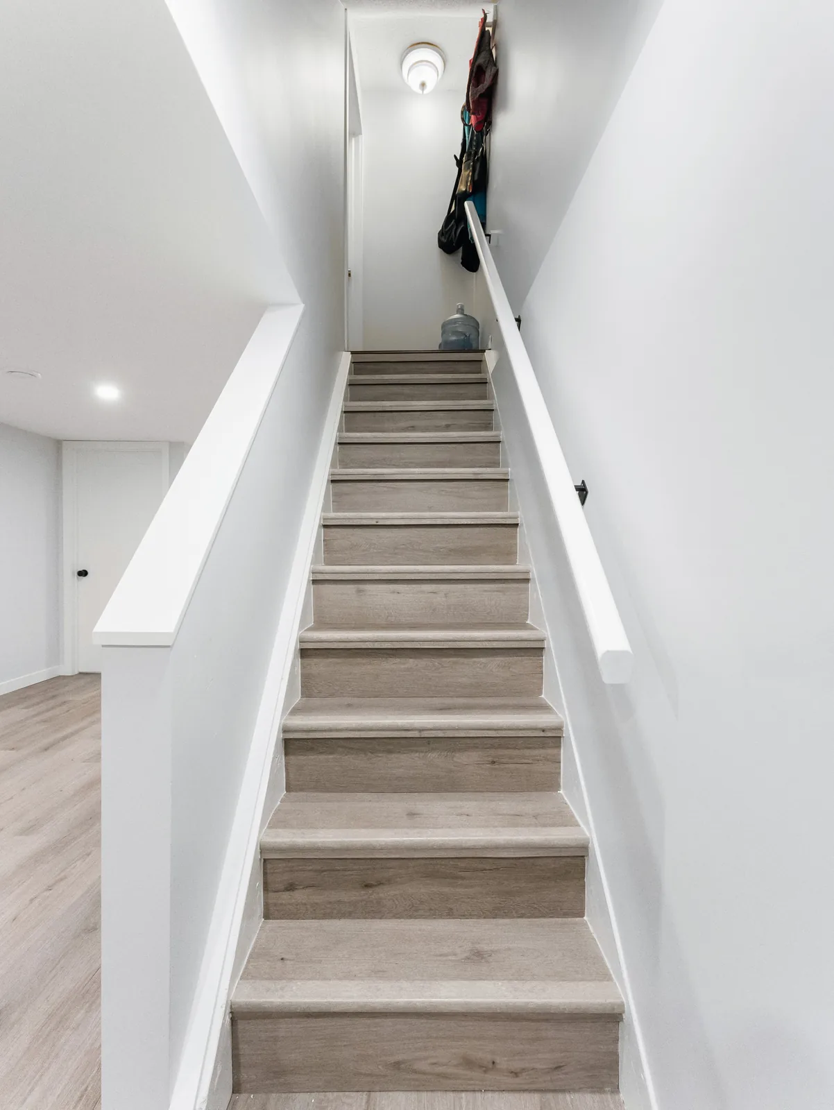 The stair from the bottom, daylight coming down from the main floor