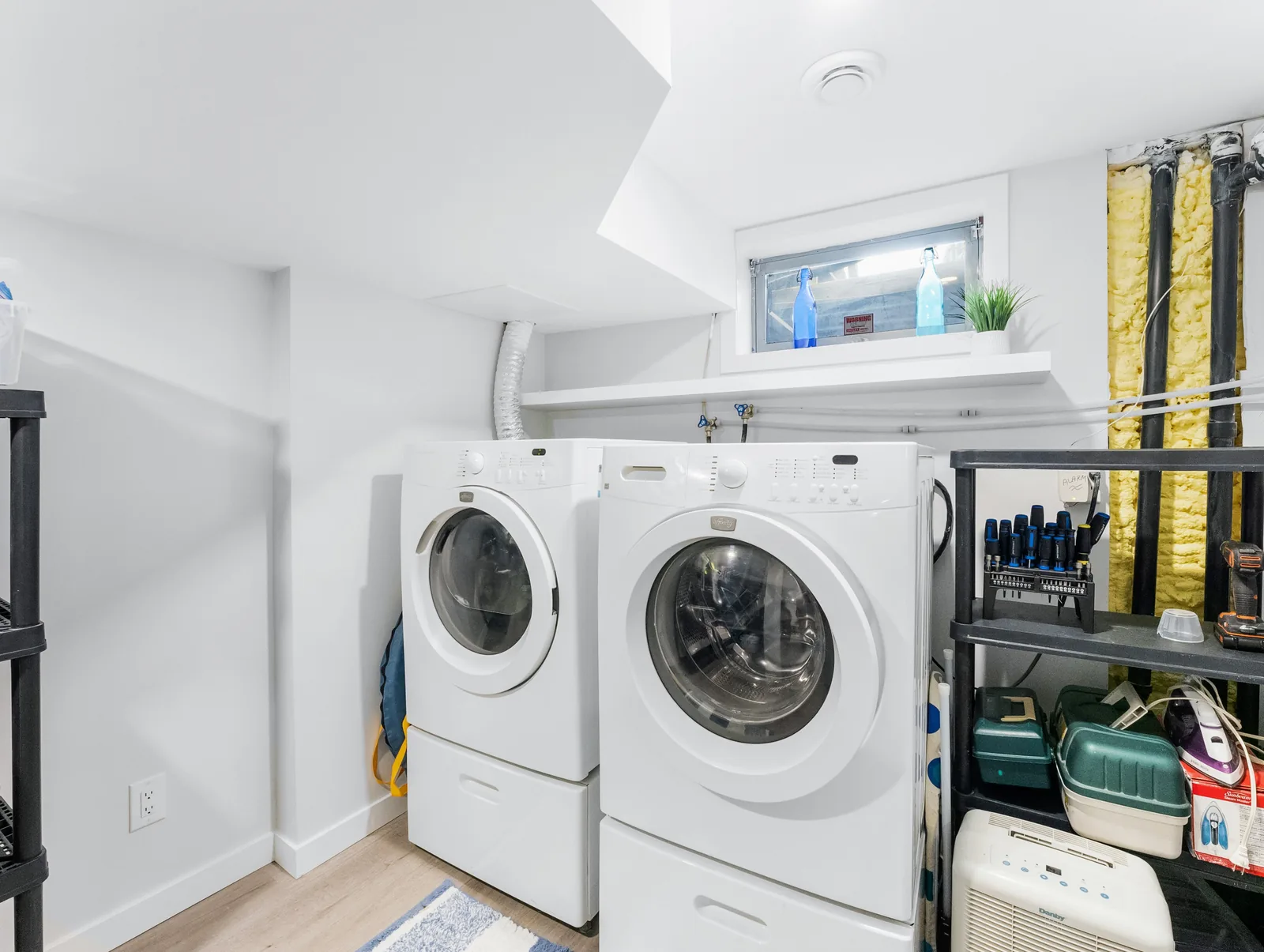 Laundry pair set under the basement window in the finished utility corner