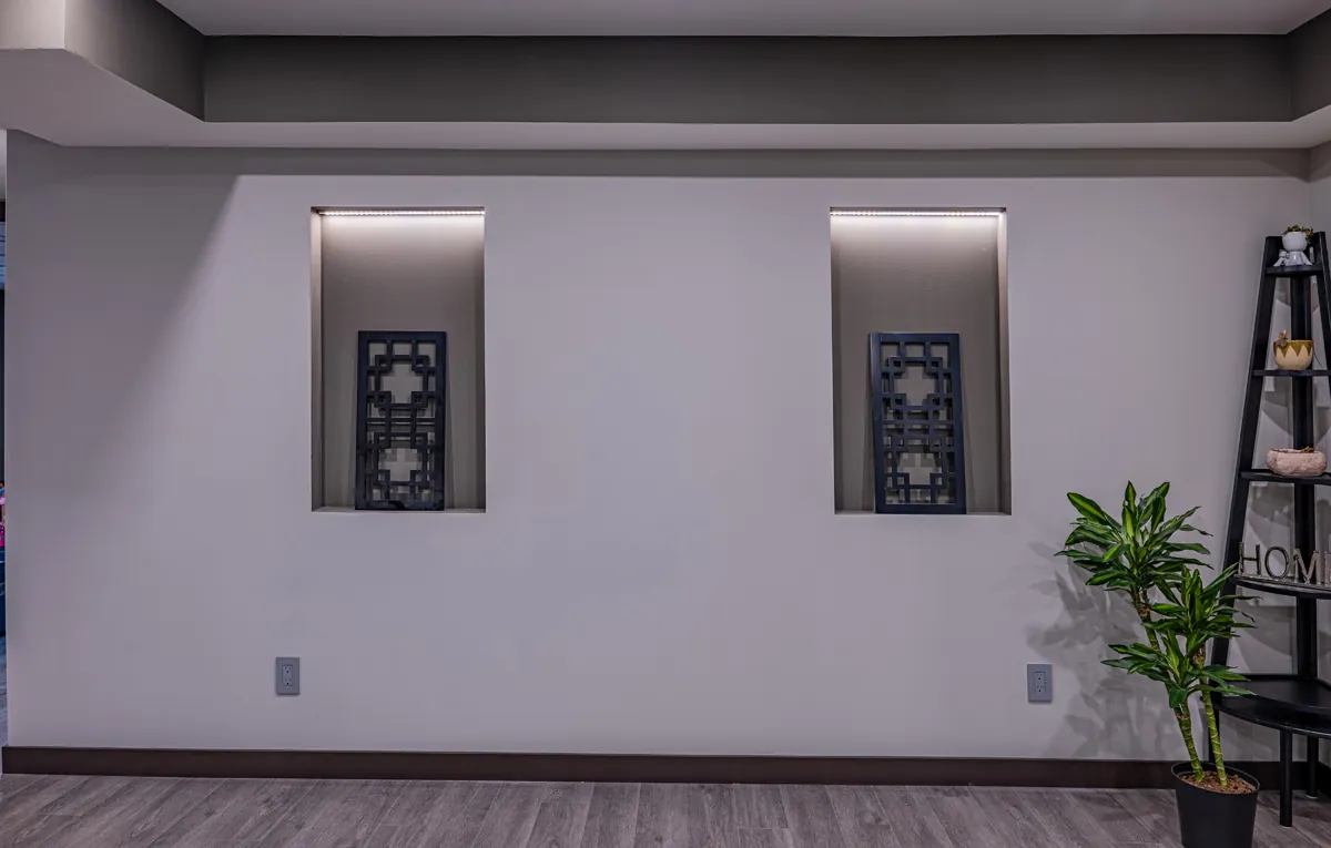 Lit display niches set into the media-room wall