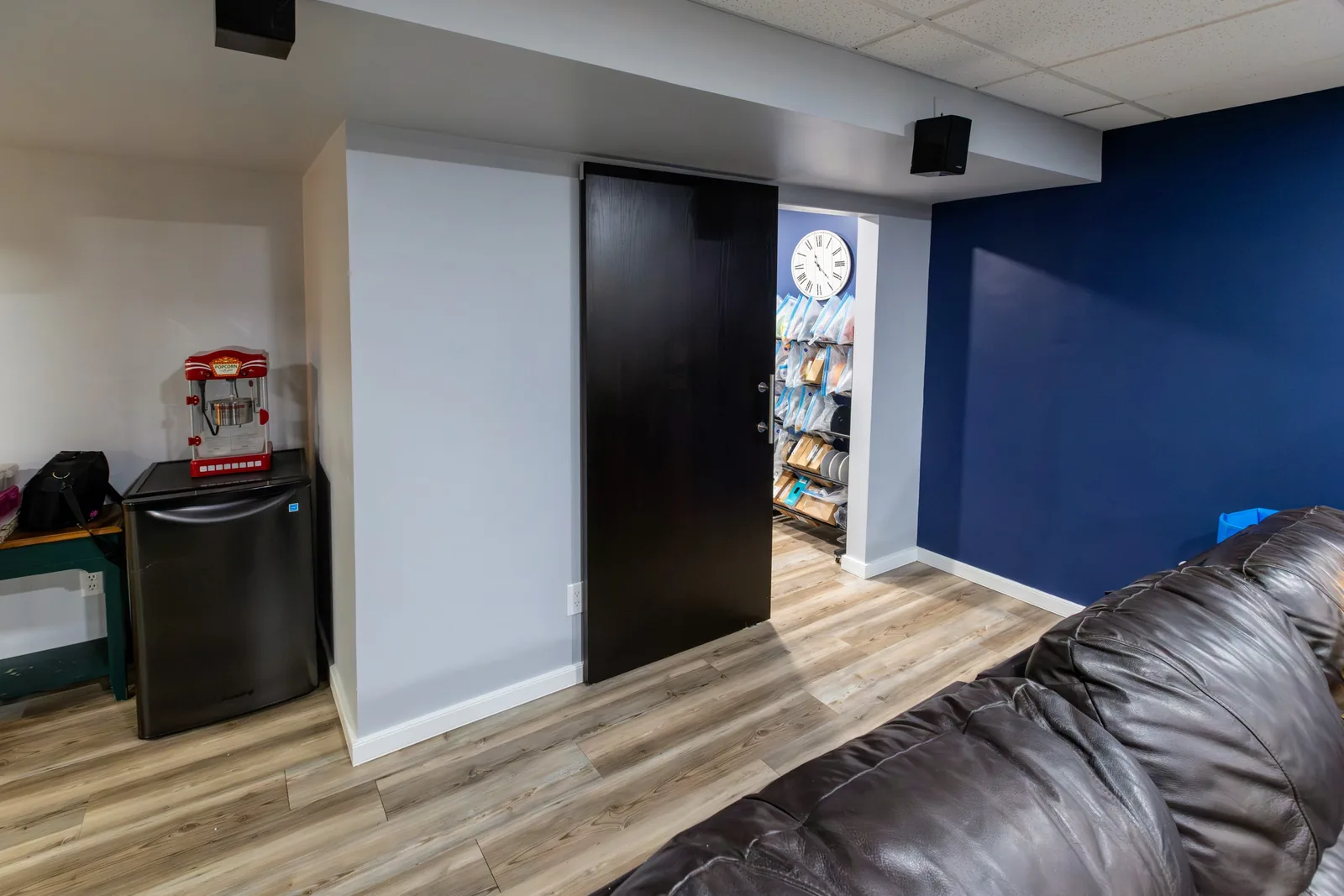 The rec room's navy feature wall and the nook beside the door