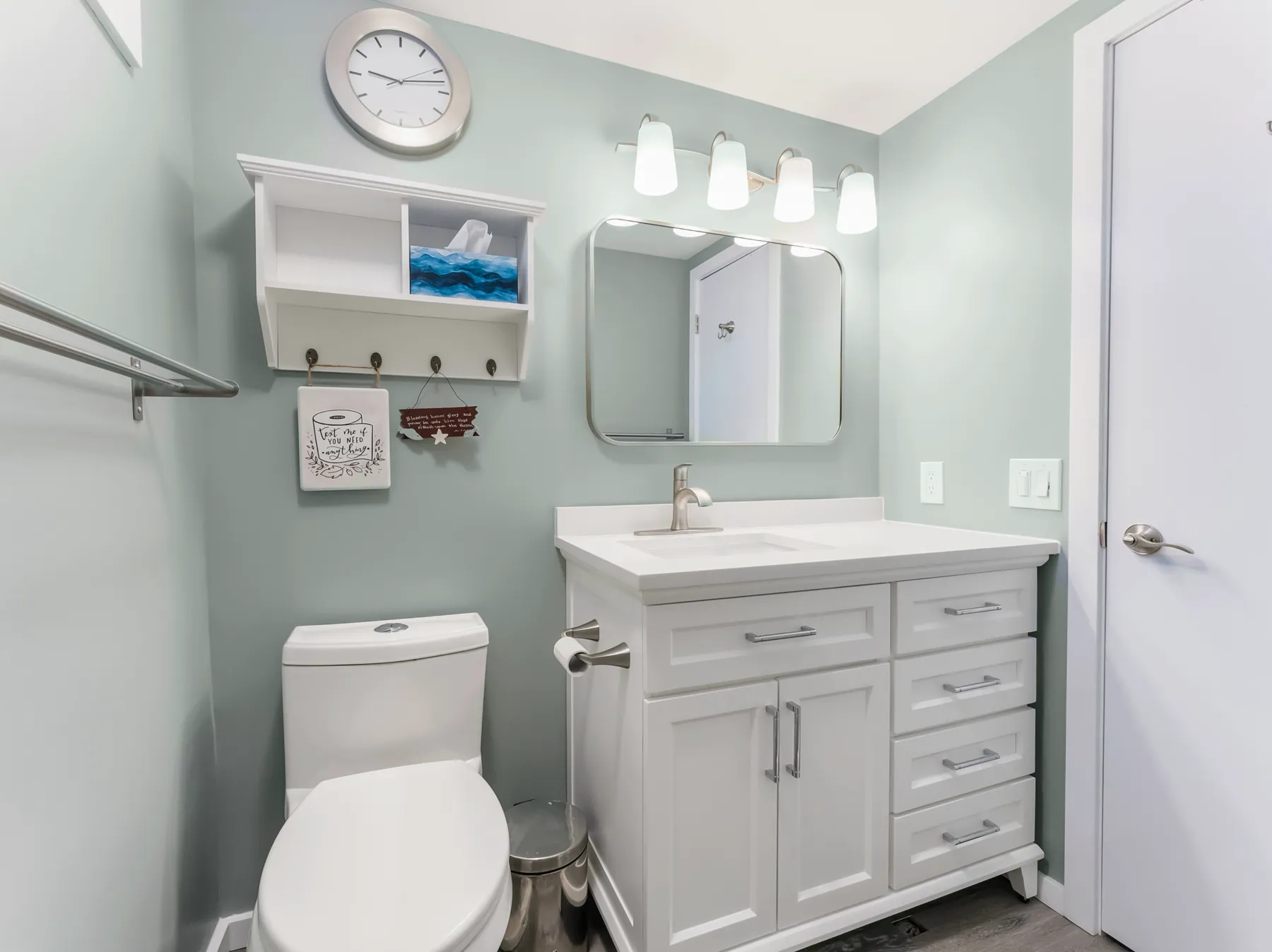 Quartz-topped shaker vanity with a grab bar on the wall alongside