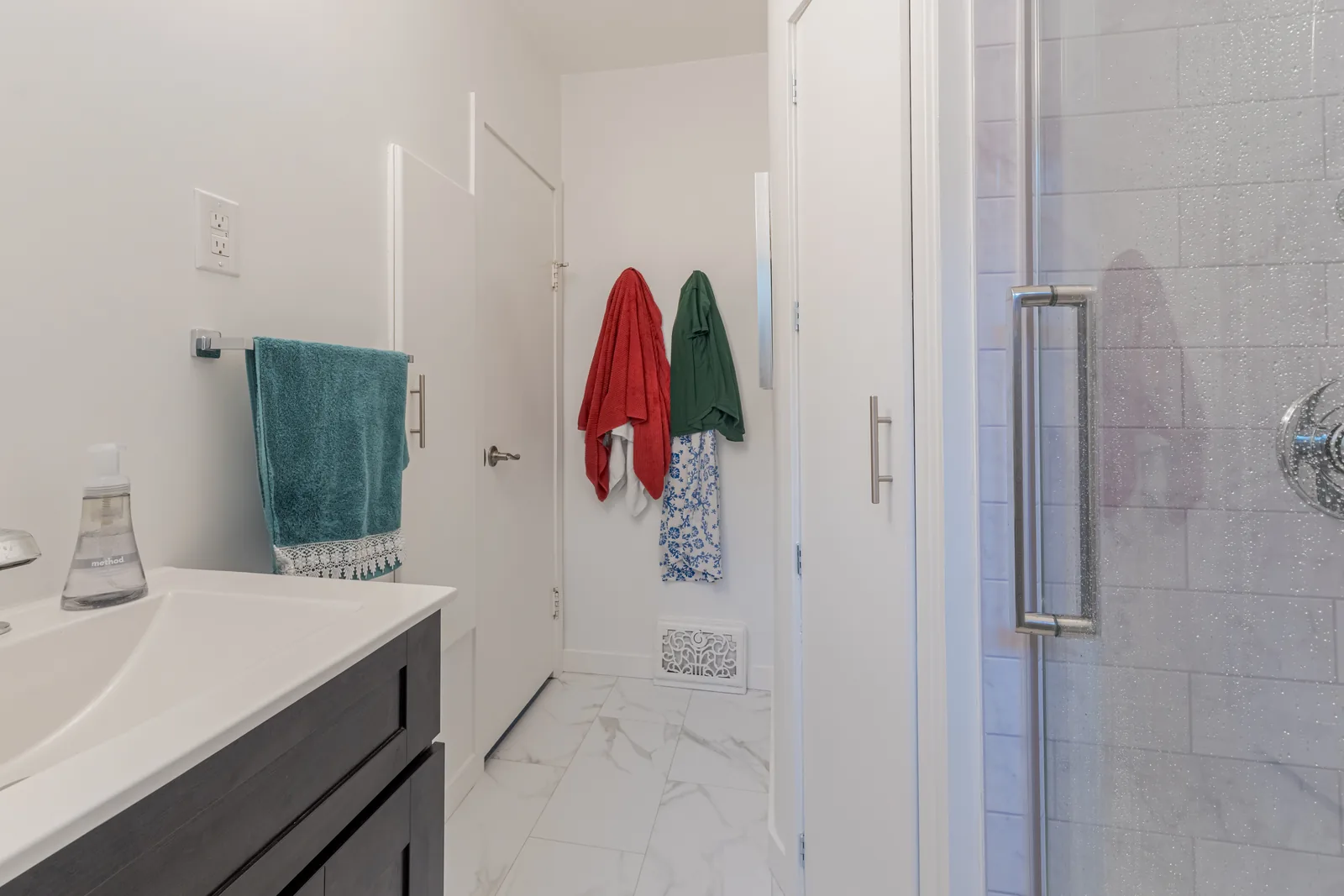 The vanity top and the shower entry, tile running behind