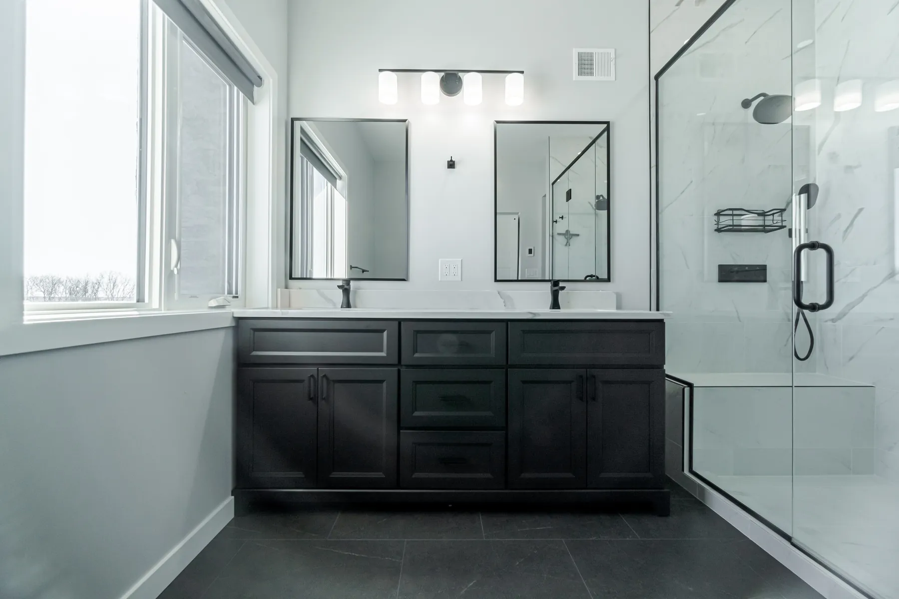 Dark double vanity with marble surround