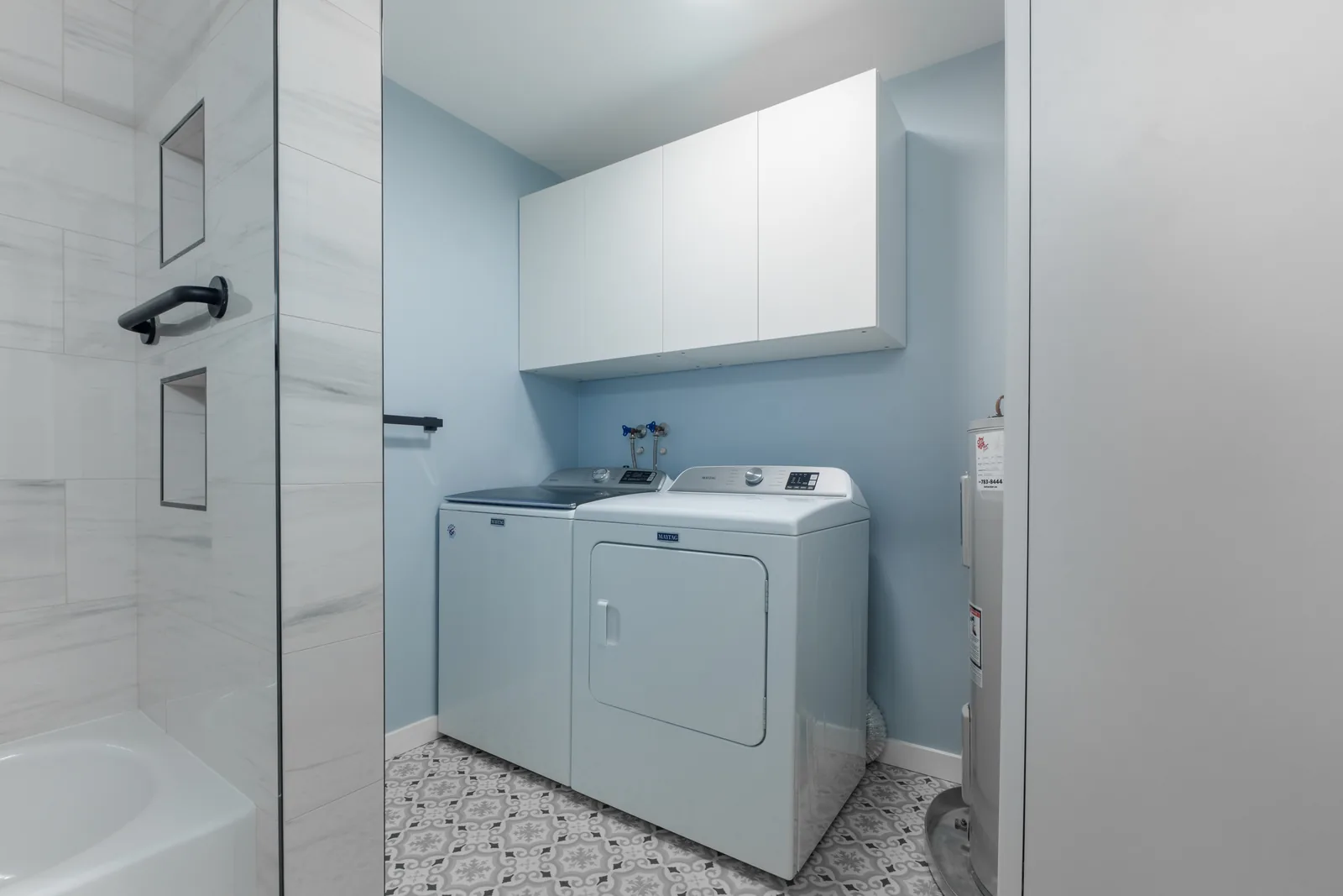 Laundry pair under new wall cabinets beside the bathroom