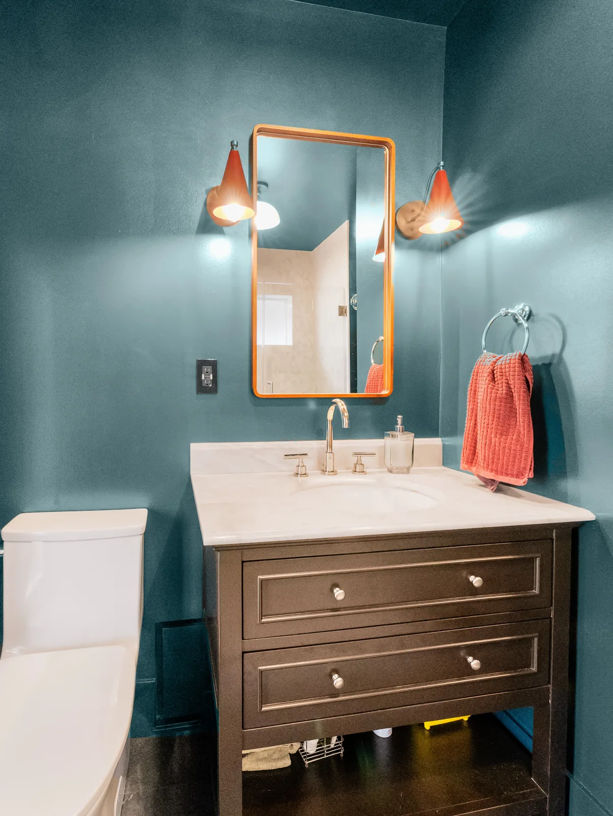 Vanity and brass mirror from the shower side of the room