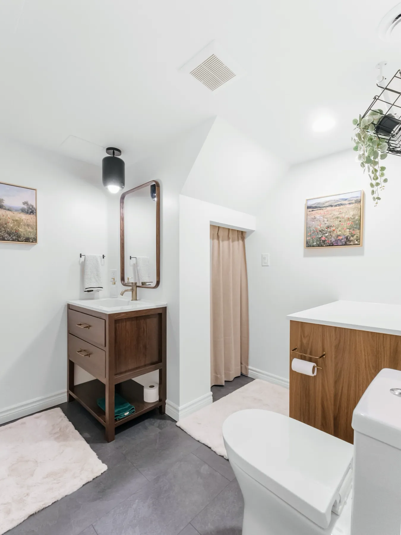 The room along its length, toilet beyond the vanity