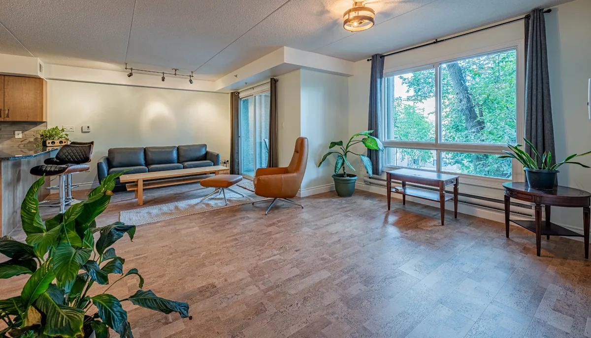 Open living space at handover, floor laid through to the balcony doors