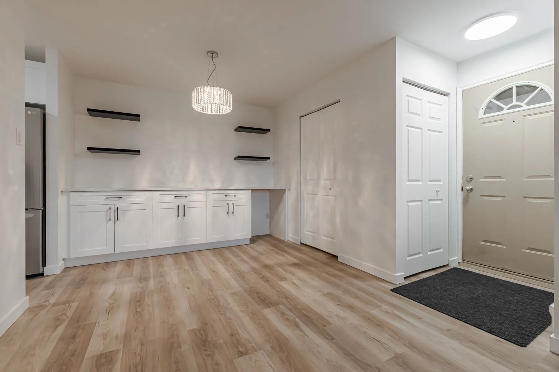 The condo entry, looking back along the cabinetry wall to the front door