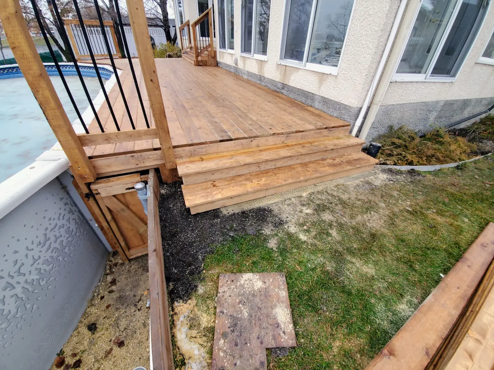 Wide cedar steps running down from the deck to the pool surround