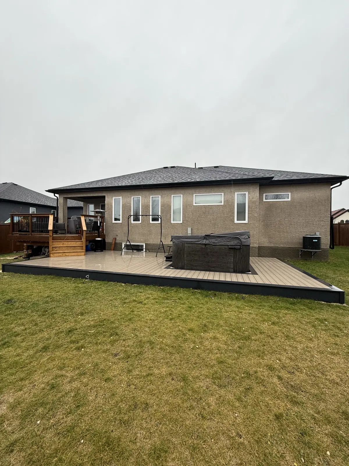 The whole rear elevation, deck and yard in one view