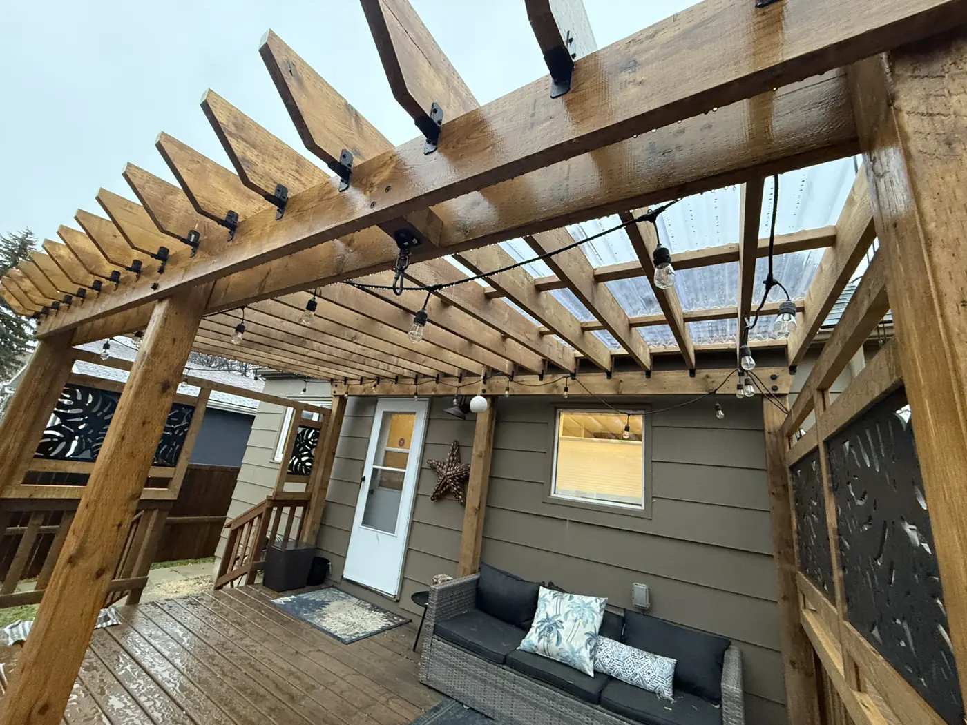 Under the pergola, looking back at the house and the seating