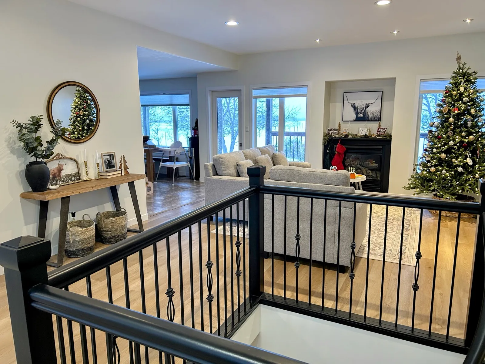 The stairwell railing from the other side, the living room beyond