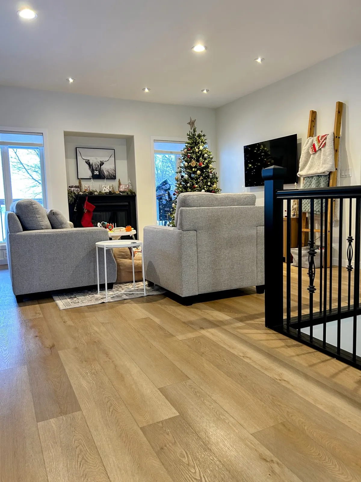 Light wide-plank flooring running into the living room
