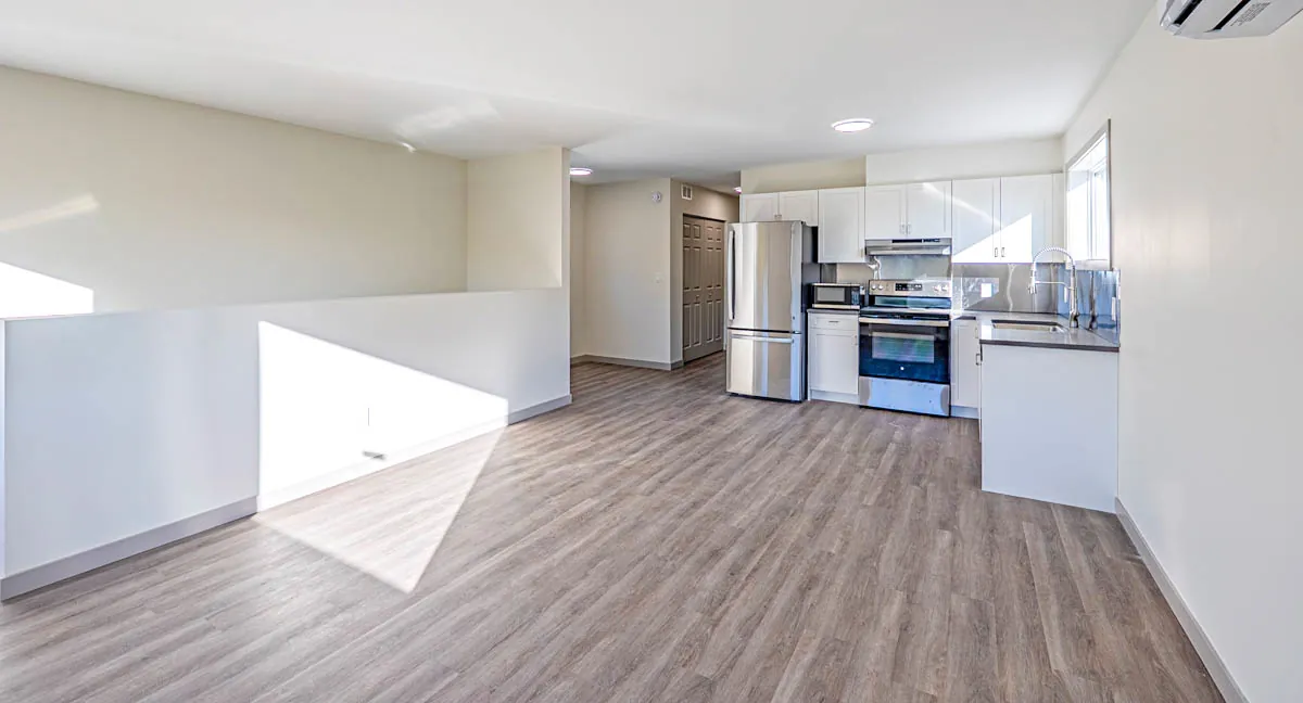 Open living area looking through to the new kitchen, vinyl plank laid throughout