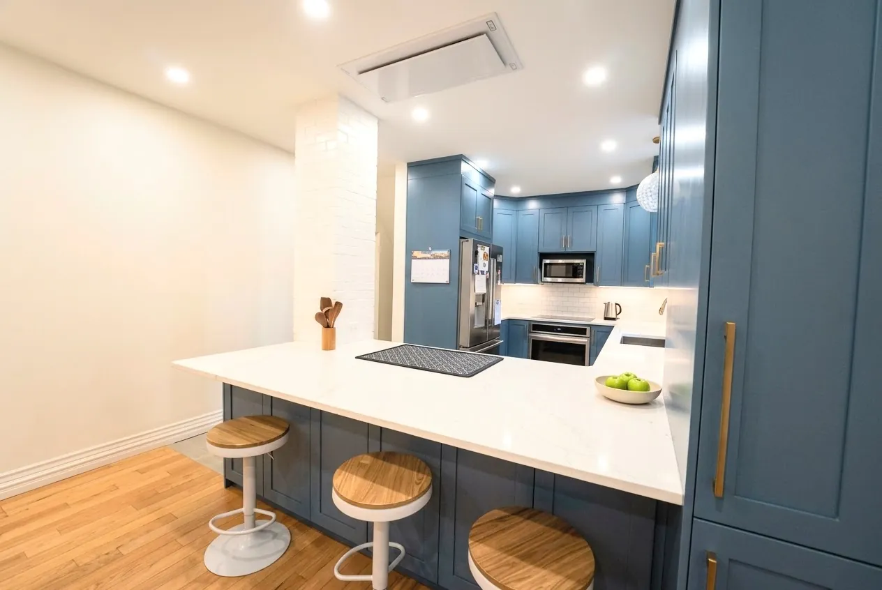 The galley from the sink, brass tap under the window and the dining wall's shelf beyond
