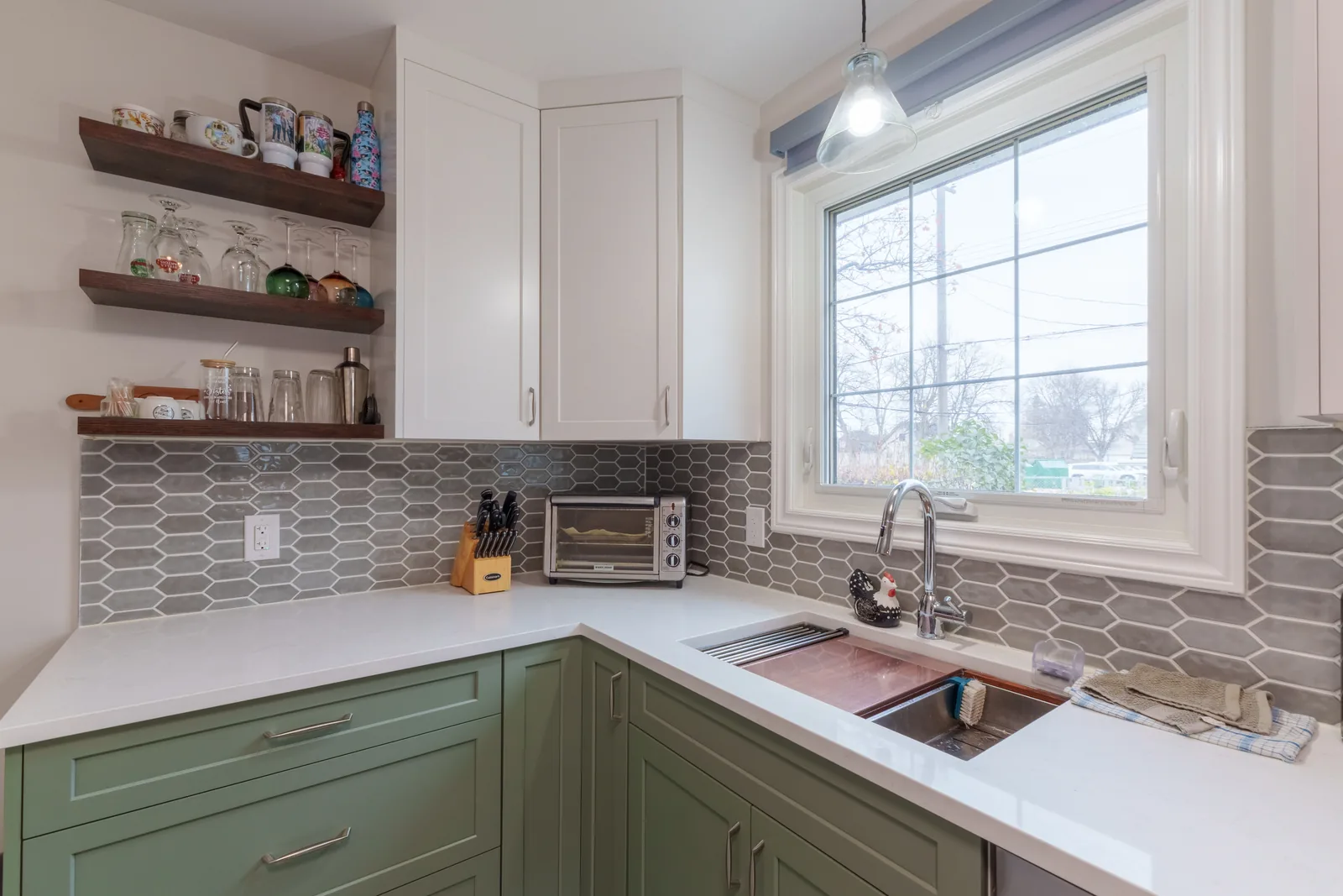 Sink run under the window, walnut floating shelves on the backsplash wall