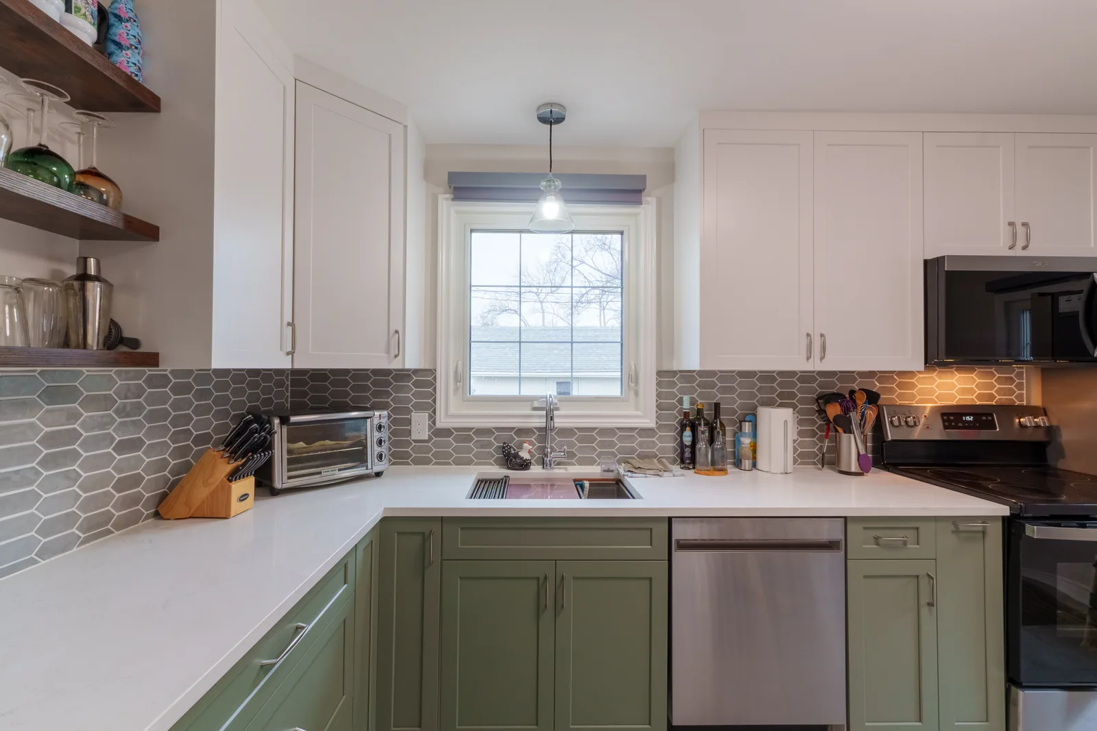 The counter run from the far end, range and stainless appliances in line