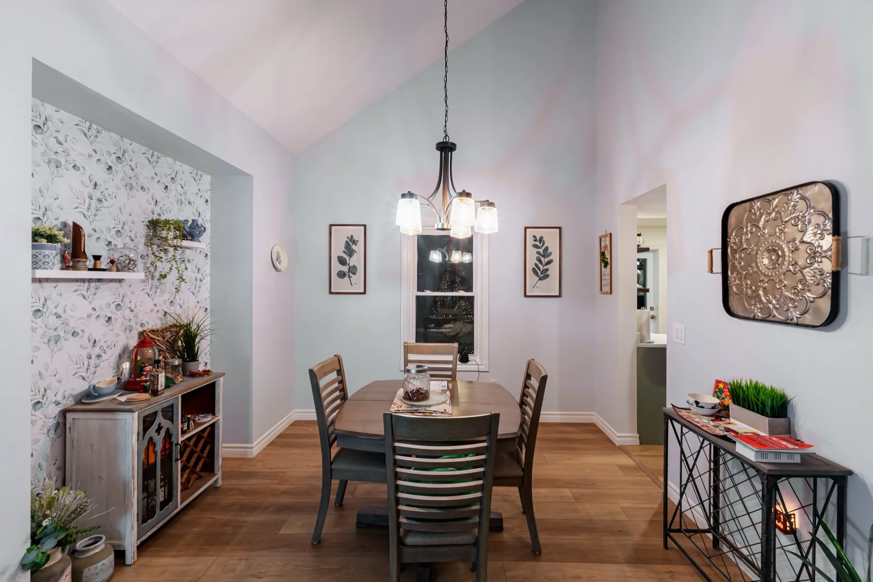 Vaulted dining room with a chandelier over the table