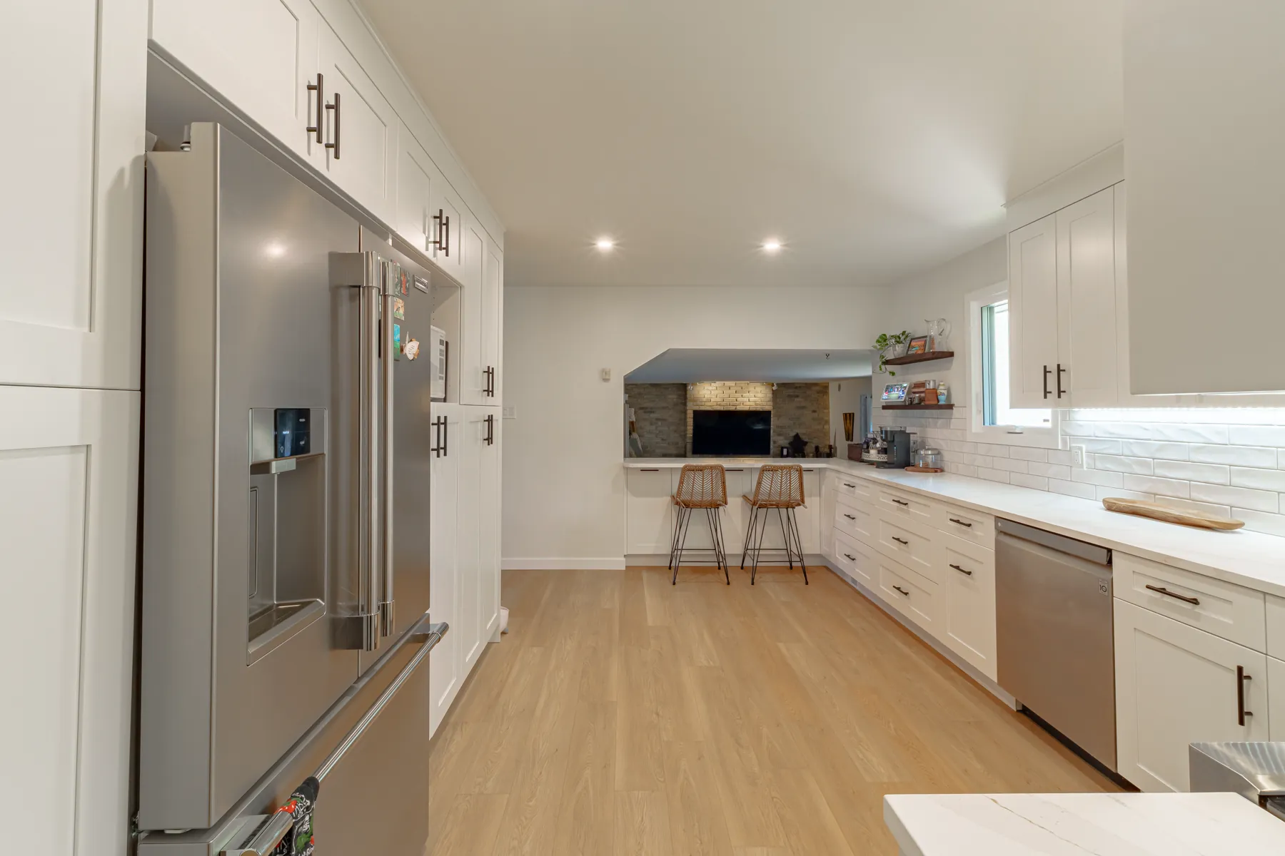 Full-height pantry and fridge wall in white shaker cabinetry