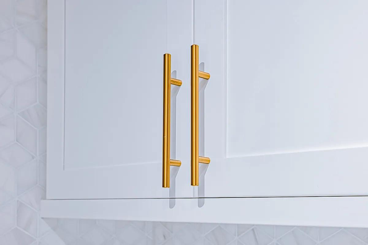 Brass bar handles on a shaker door, close up