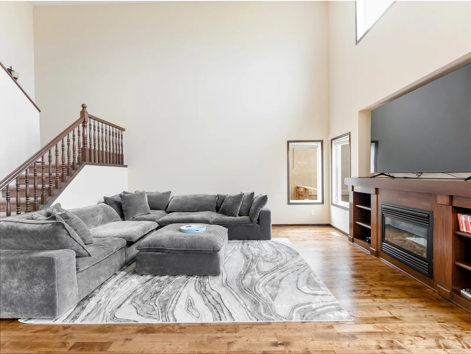 Vaulted living room on the main floor, fireplace and built-ins along the far wall