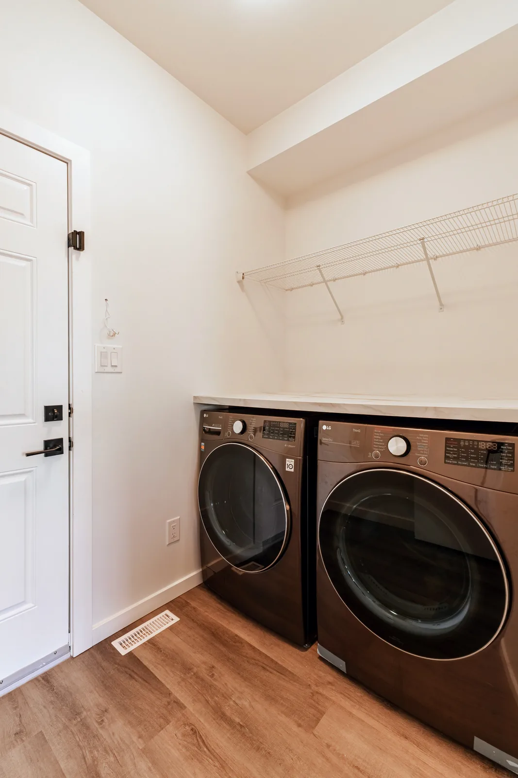 Laundry pair under a new stone counter in its own fitted alcove
