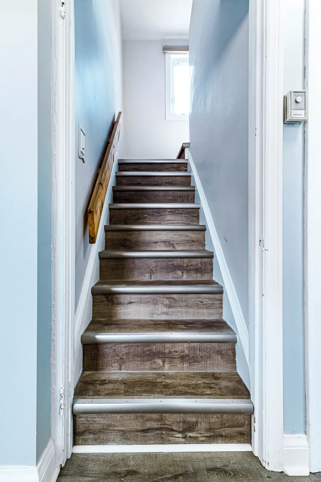 Rebuilt stair with plank treads running to the upper floor