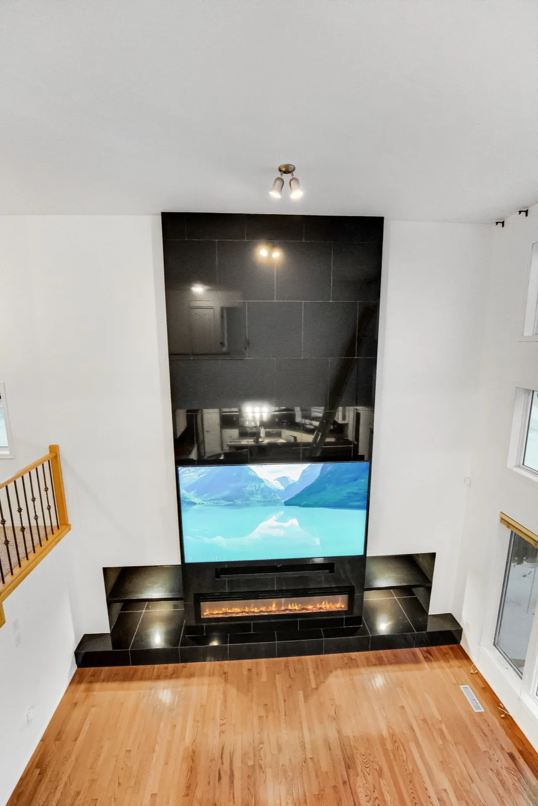 The tile column straight on from the landing, the TV and fireplace set into it