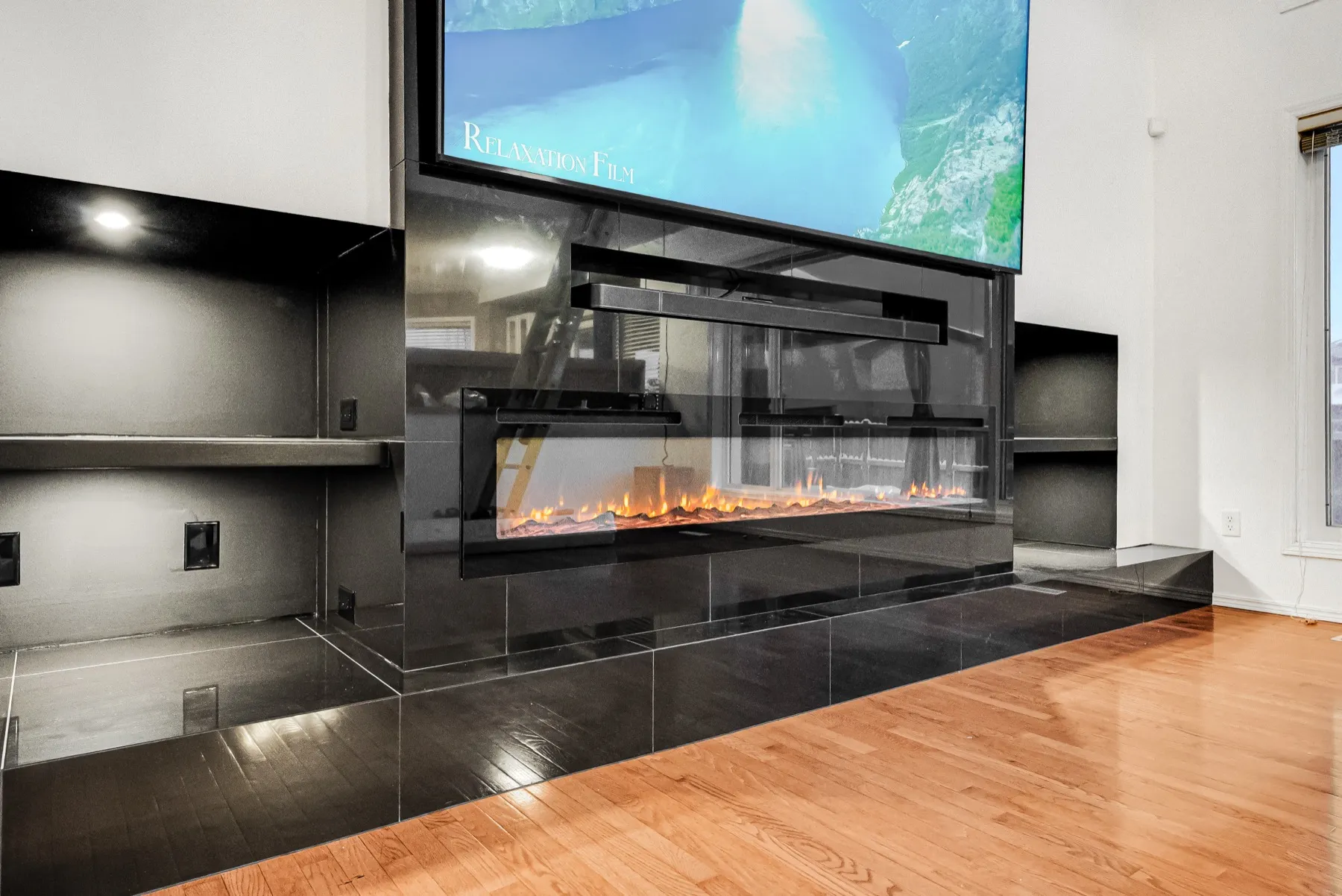 Close on the fireplace and the black tile hearth
