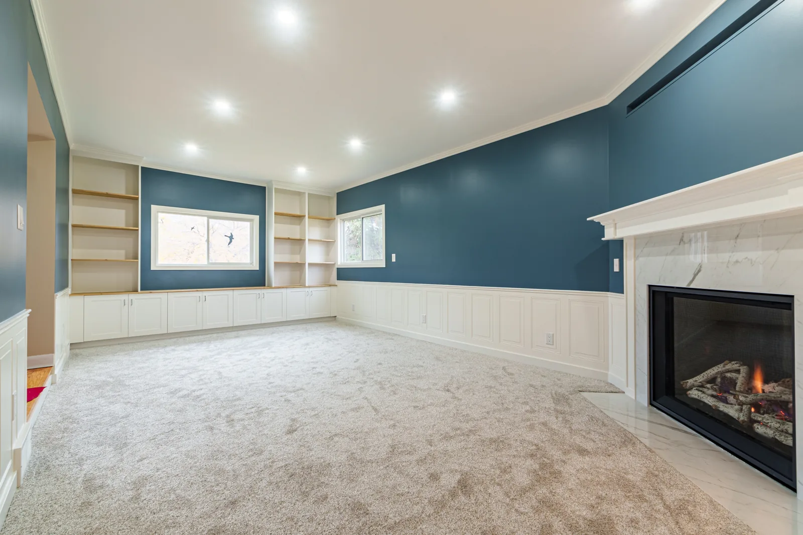 Vaulted living room looking back to the fireplace and its built-ins