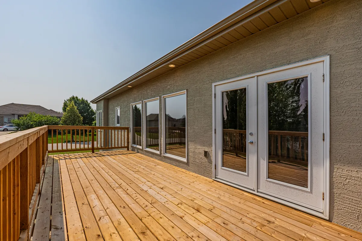 Cedar deck running the width of the house, with french doors onto it