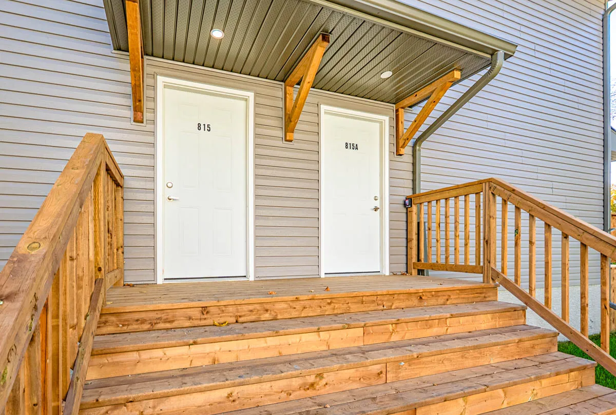 The front landing, two separate entry doors side by side under one canopy