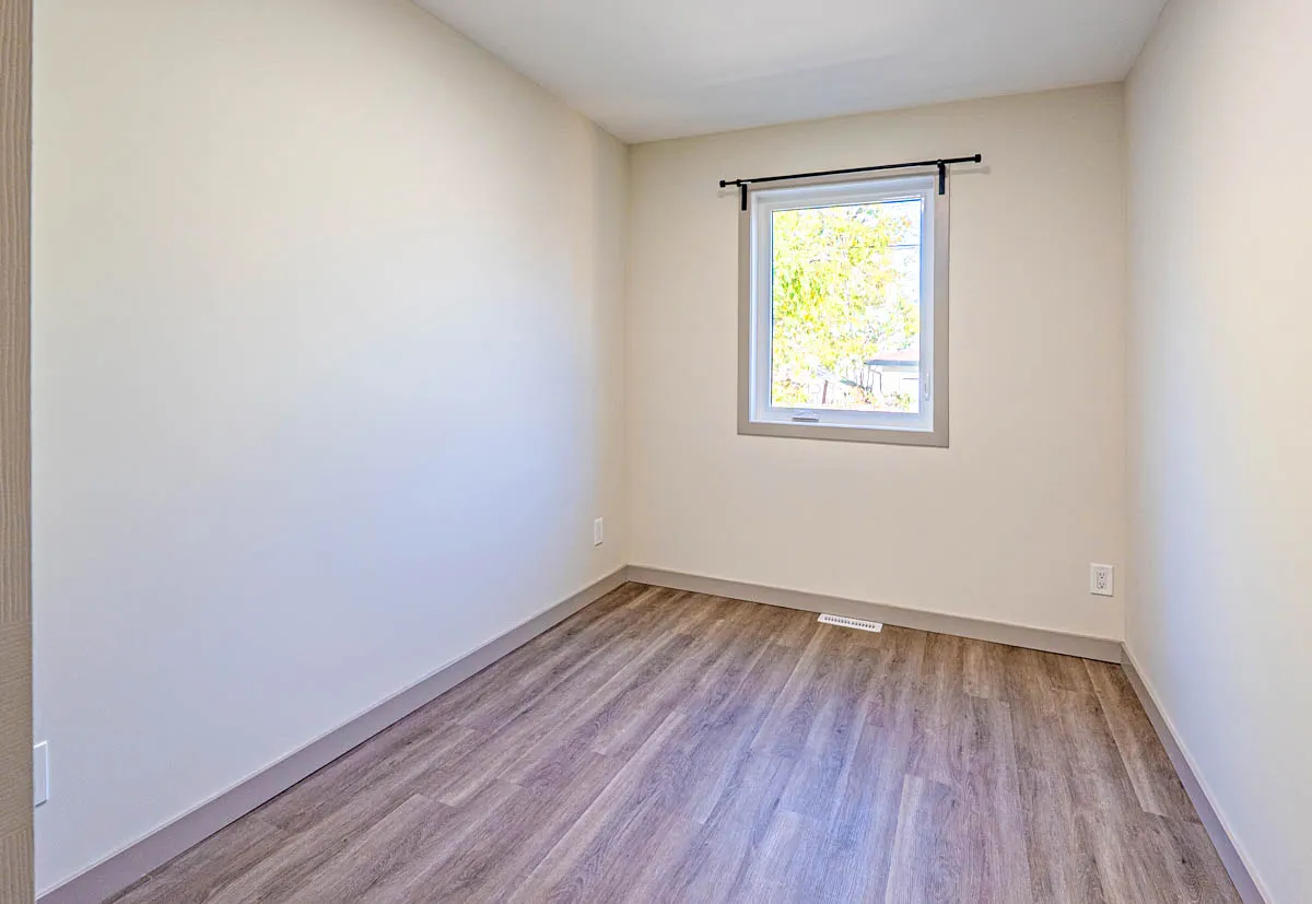 A second bedroom lit by a single window