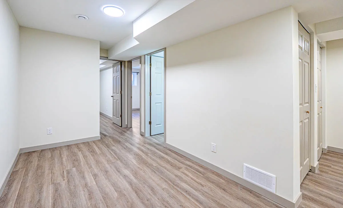 The basement hall leading to the rooms beyond