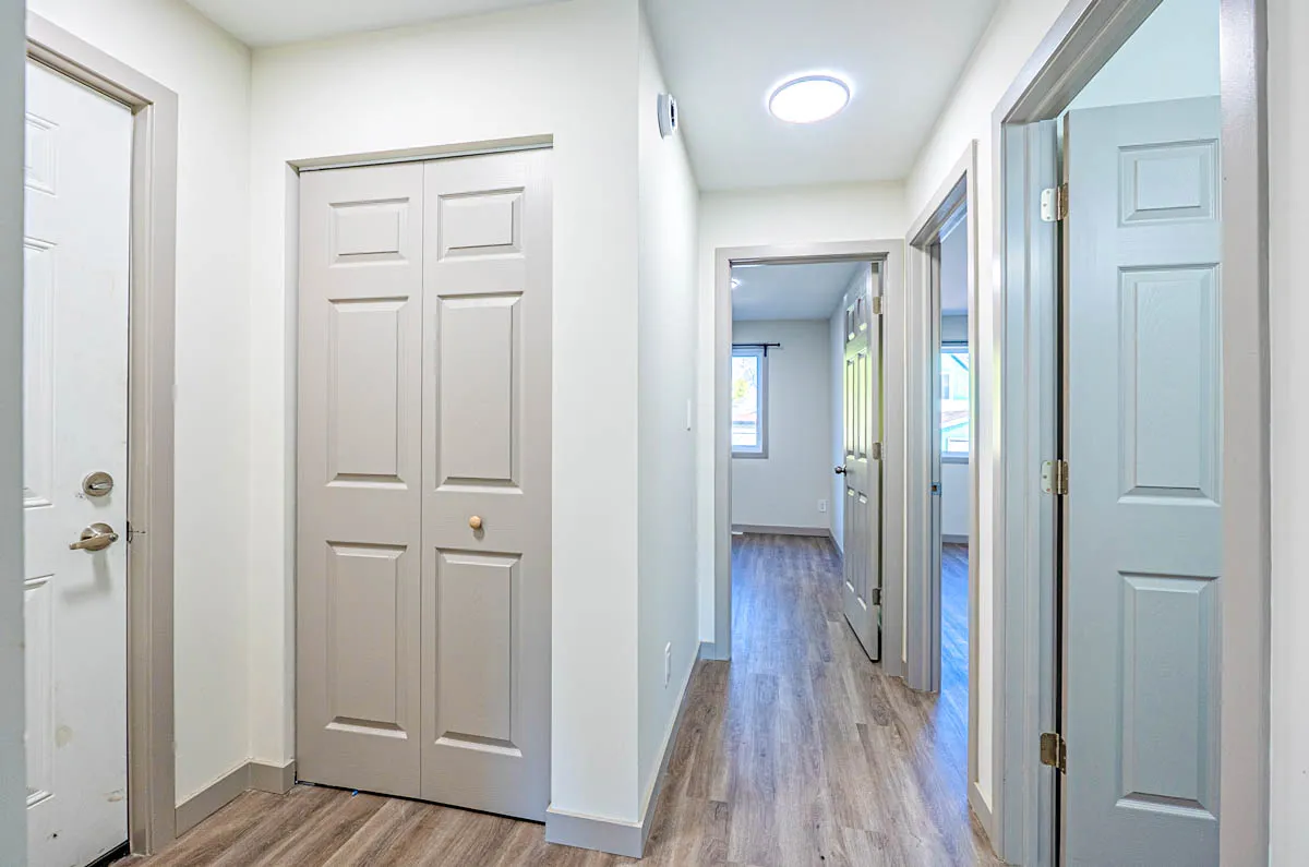A short basement hall lined with doors