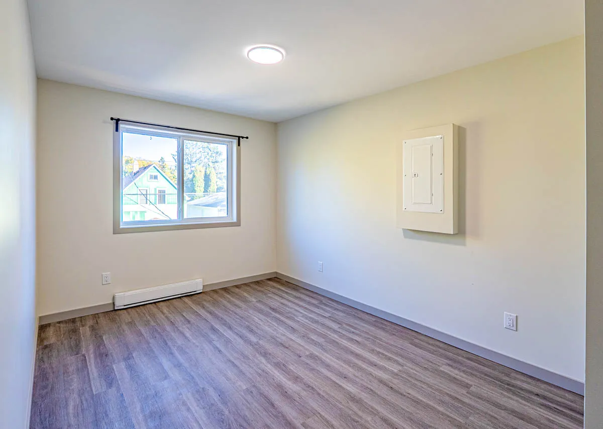 A bright bedroom with a window on the side wall
