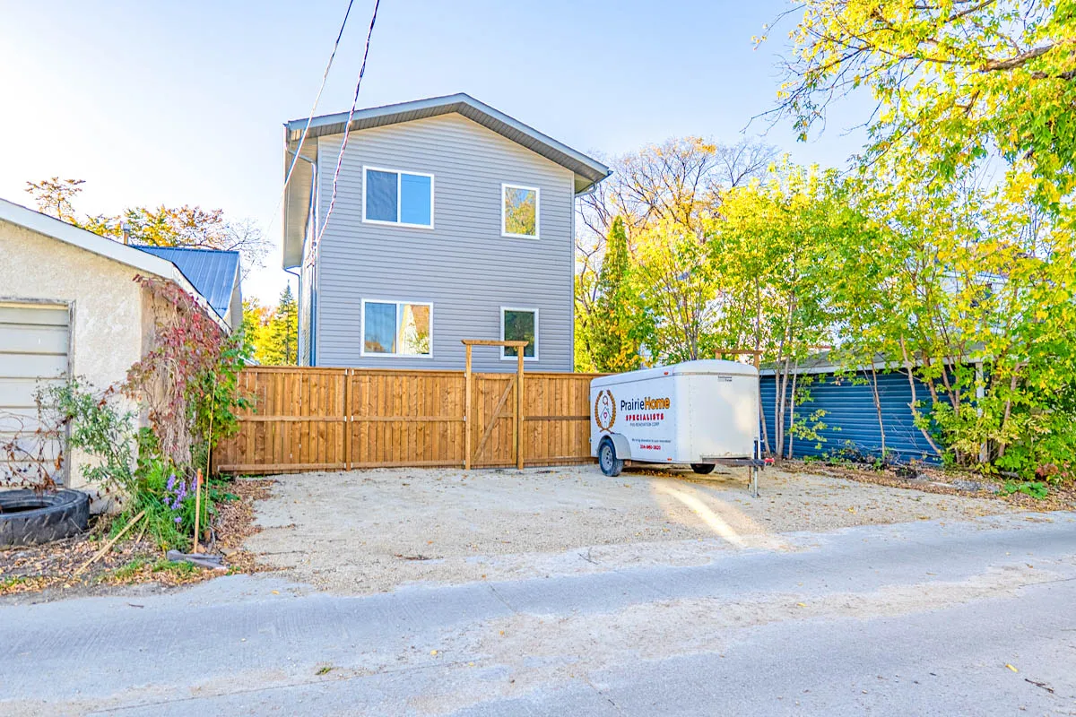 The back of the duplex from the lane, a new fence along the yard