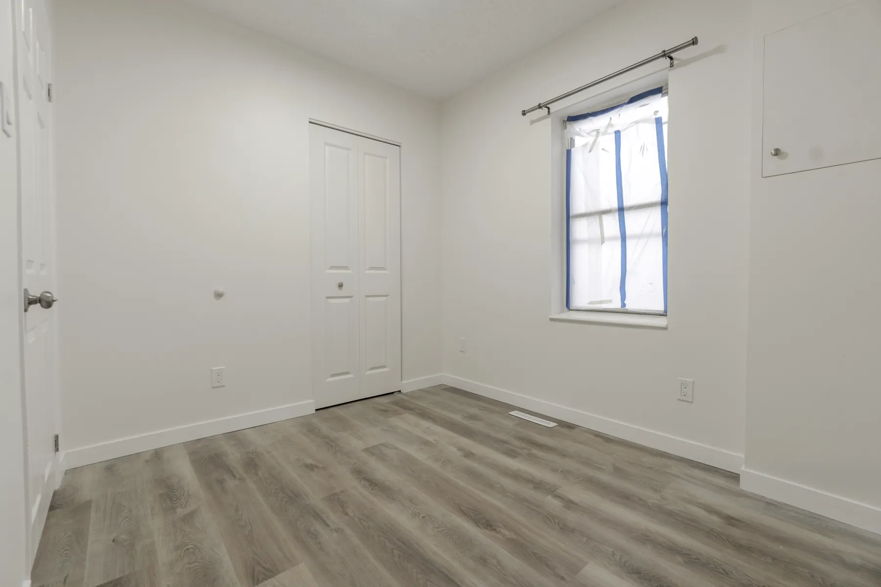 A bedroom, vinyl plank laid through