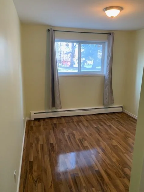 A bedroom with the plank flooring laid through and the window redressed