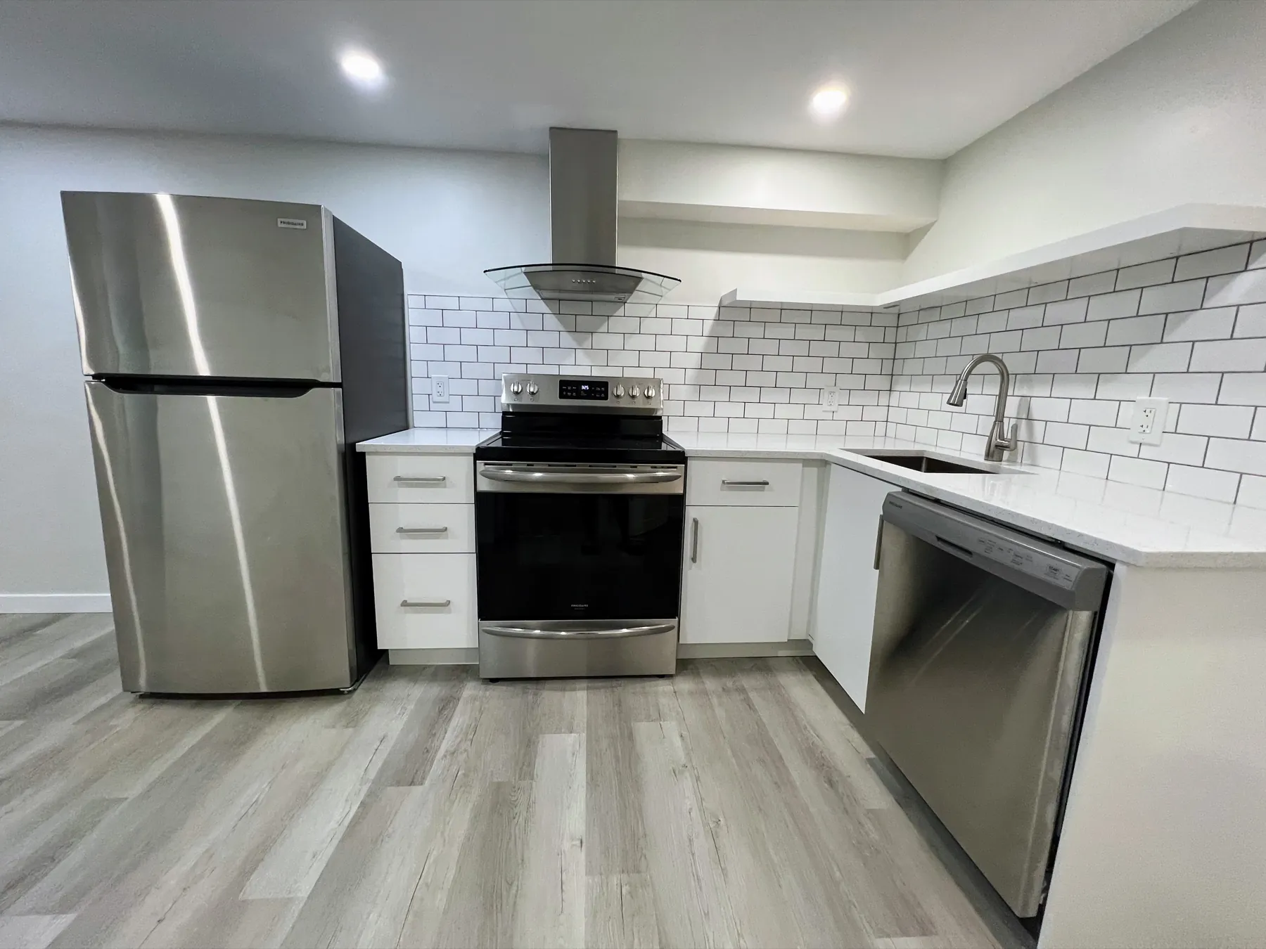 The suite's own kitchen, subway tile behind the range