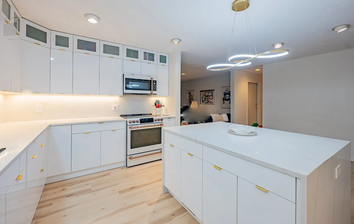 The range wall and island, the ribbon pendant hung toward the living room