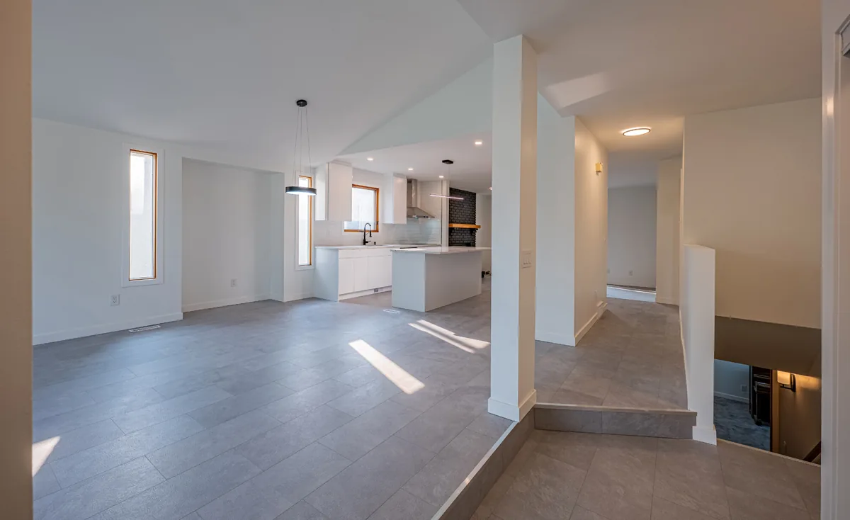Living room opened through to the kitchen under a vaulted ceiling