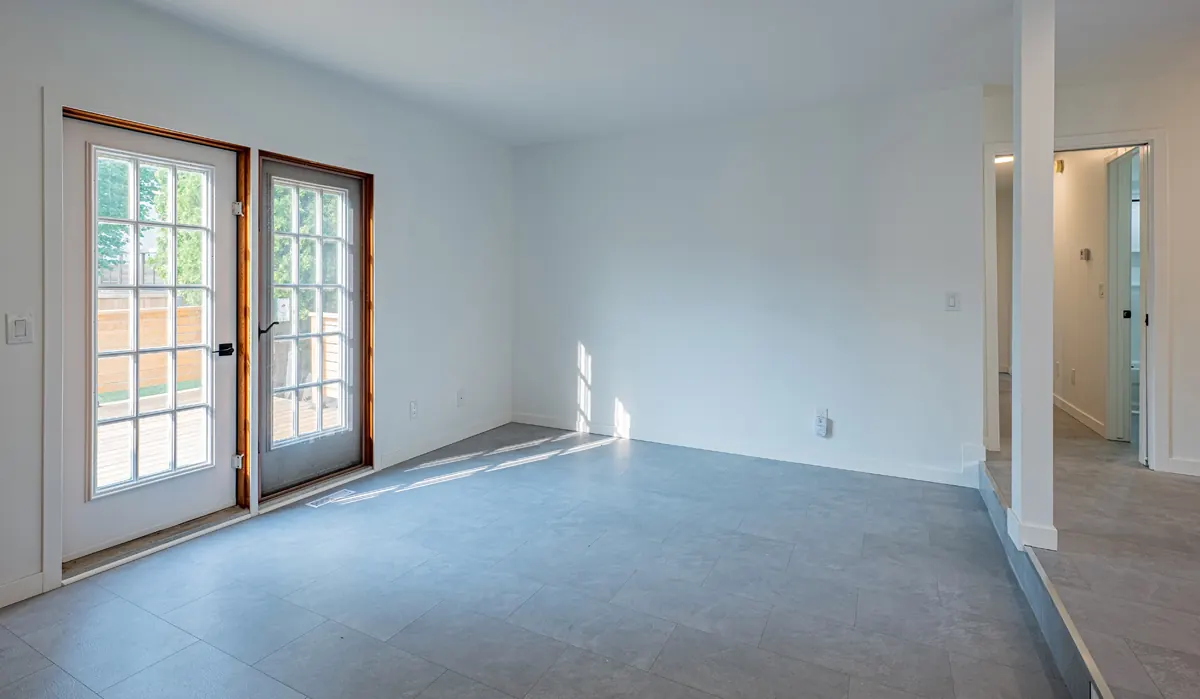 A tiled room off the kitchen with french doors out to the deck
