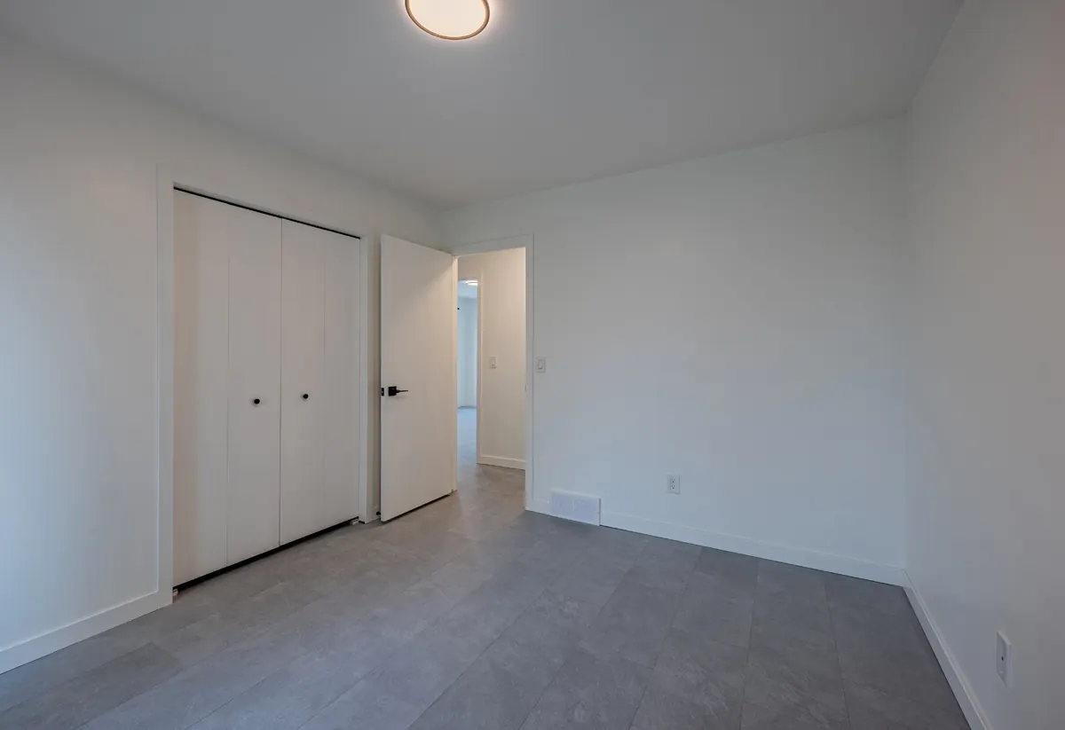Bedroom with a white double-door closet