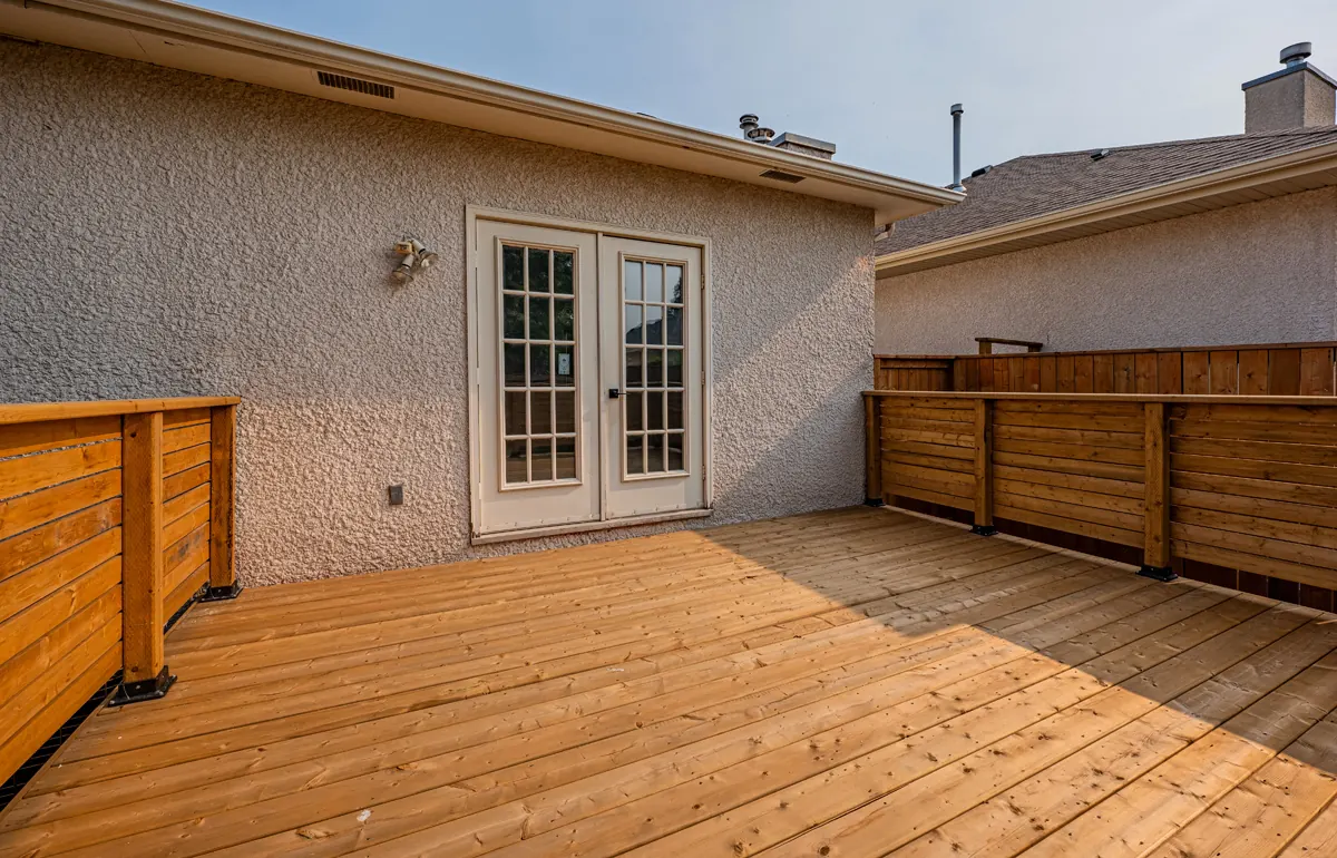 On the deck, new boards running to the french doors between slatted screens