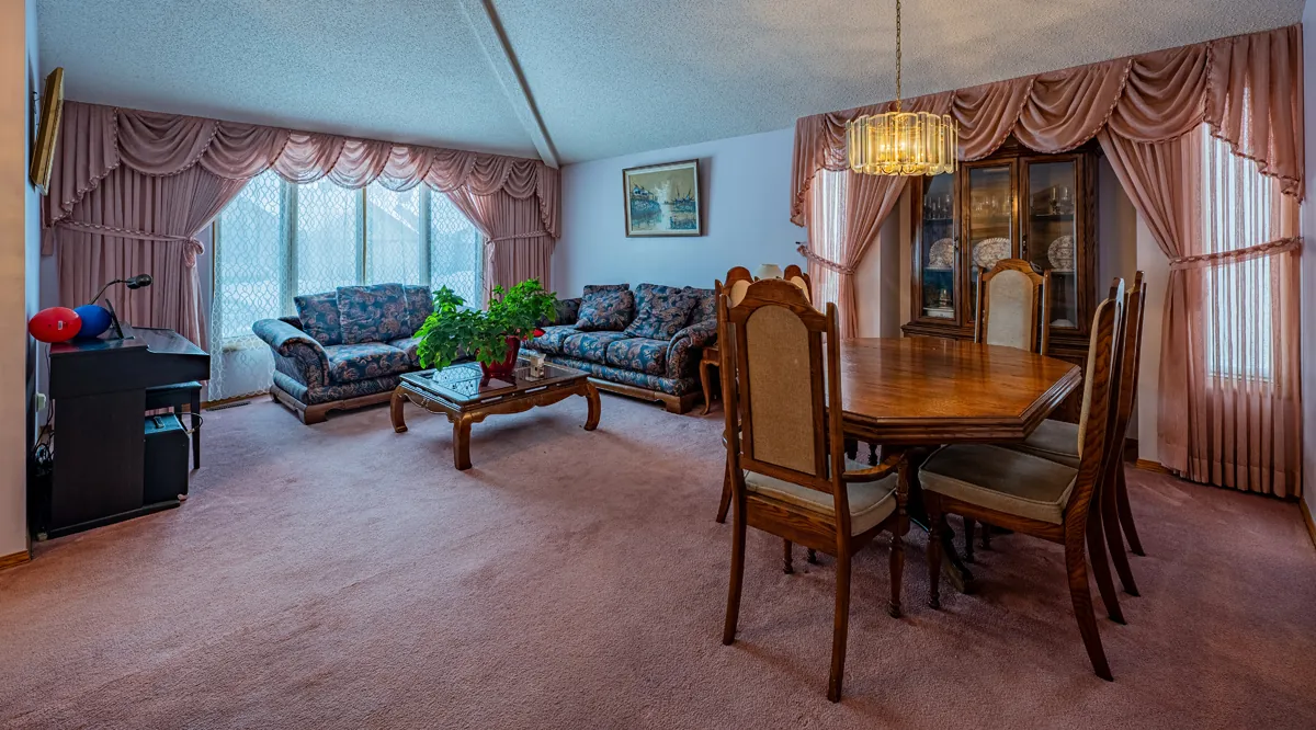 Before: the living and dining room under the vault, pink carpet and heavy drapes
