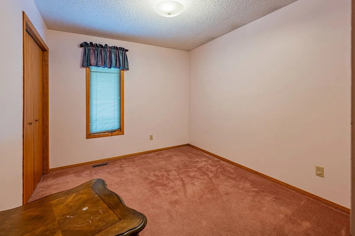 Before: a second bedroom, carpeted, with oak doors