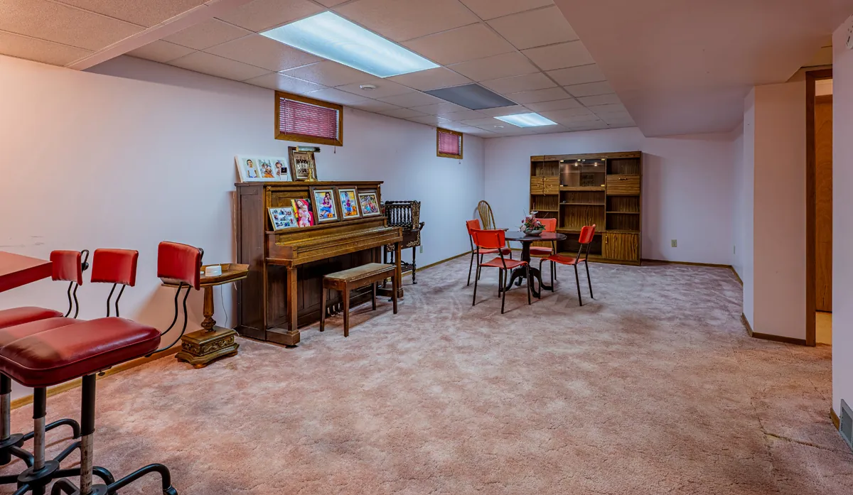 Before: the basement rec room with a piano